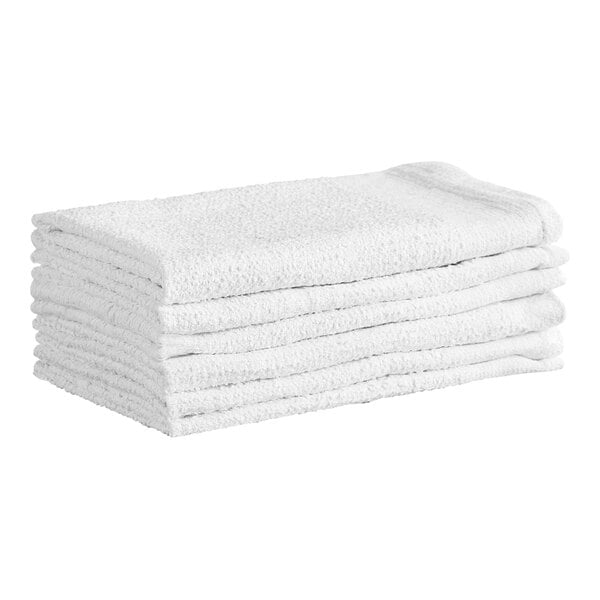 A stack of white terry cloth towels is neatly arranged on a white background.