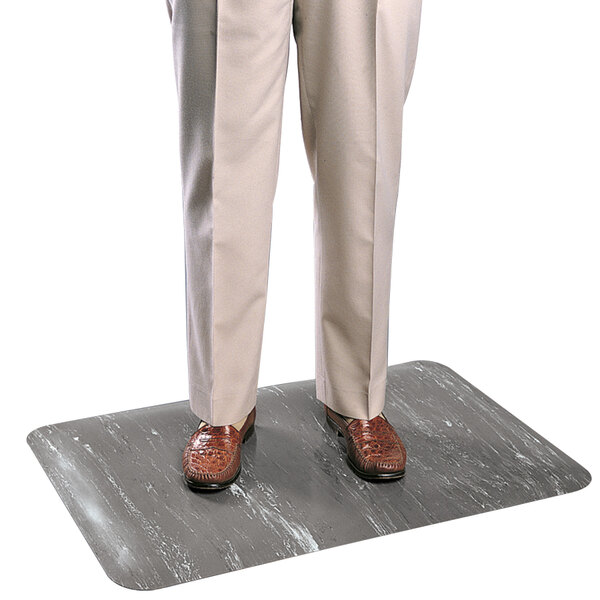 A person standing on a Cactus Mat cushion comfort anti-fatigue mat.