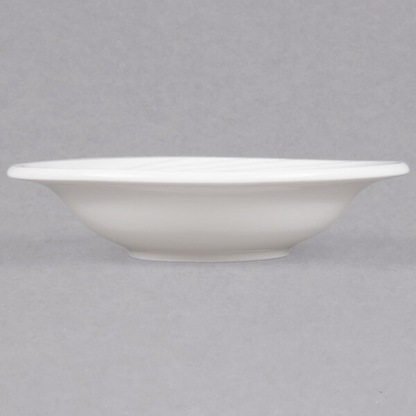 A close up of a CAC white porcelain fruit dish with a rim.