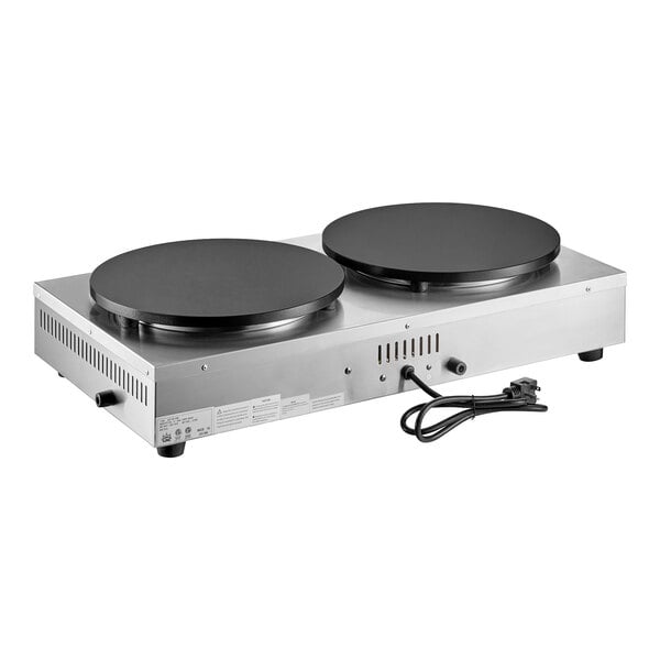 A dual non-stick electric crepe maker with two large round cooking surfaces and a stainless steel base.