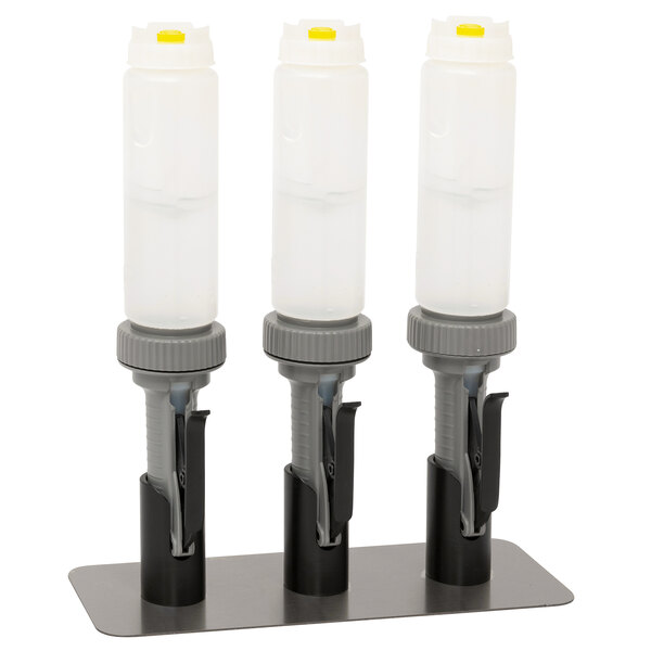 A Nemco countertop stand with three hand sanitizer pumps.