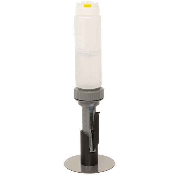 A white plastic Nemco hand sanitizer bottle with a grey lid on a black metal stand.