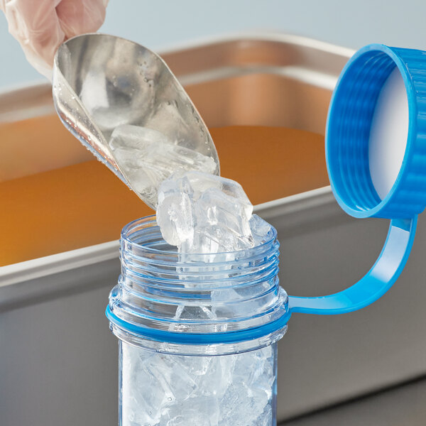 A person using a Vigor Polar Paddle to scoop ice into a clear container.