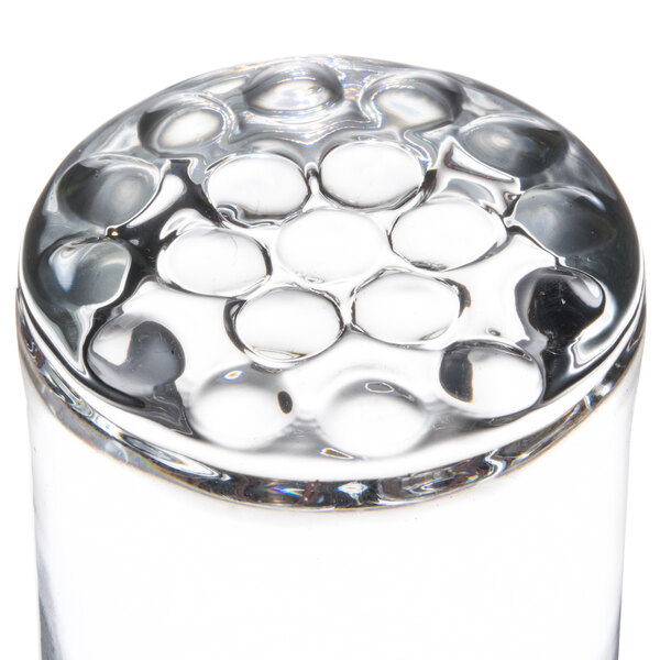 A Libbey highball glass on a table in a bar.