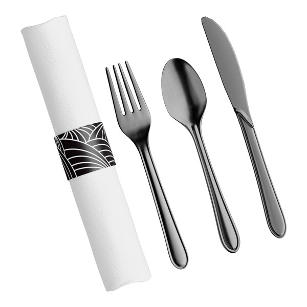 A pre-rolled white linen-like napkin with a black patterned band, accompanied by a black plastic fork, spoon, and knife.