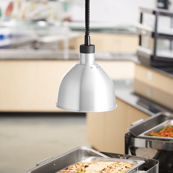 A stainless steel food tray under a ServIt ceiling mount heat lamp.