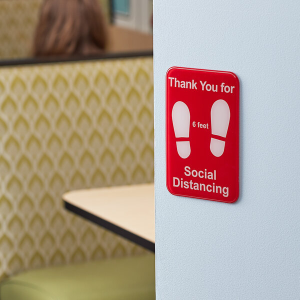A red and white Tablecraft plastic sign that says "Thank You for Social Distancing"
