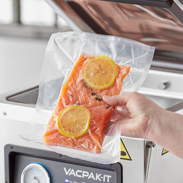 Vaccum wrapped salmon with lemon and dill prepared for cooking in sous vide machine