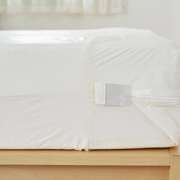 A white Bargoose bed with a white sheet on it.