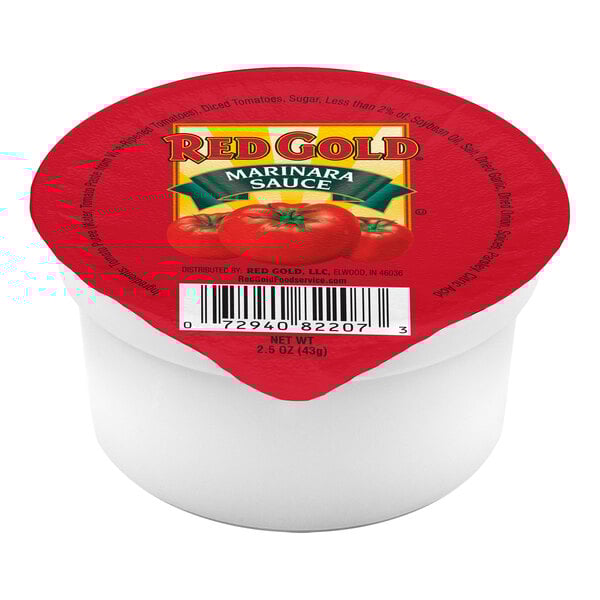 A white container with a red label reading "Red Gold Marinara Sauce" filled with tomato sauce.