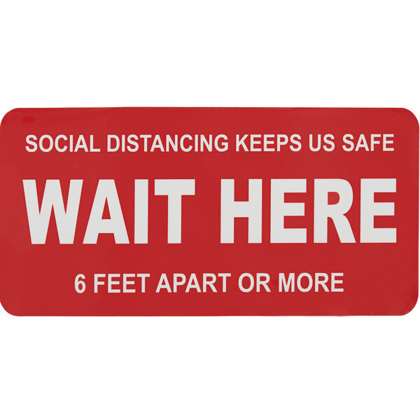 A red Tablecraft "Wait Here" social distancing floor decal with white text.