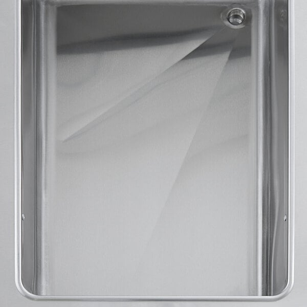 A ServIt electric steam table with a hole in the metal surface above a metal tray.