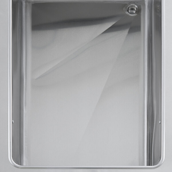 A metal steam table with a hole in it.