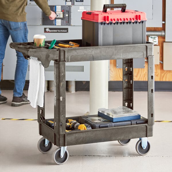 A man standing next to a black Lavex utility cart with built-in tool compartments.