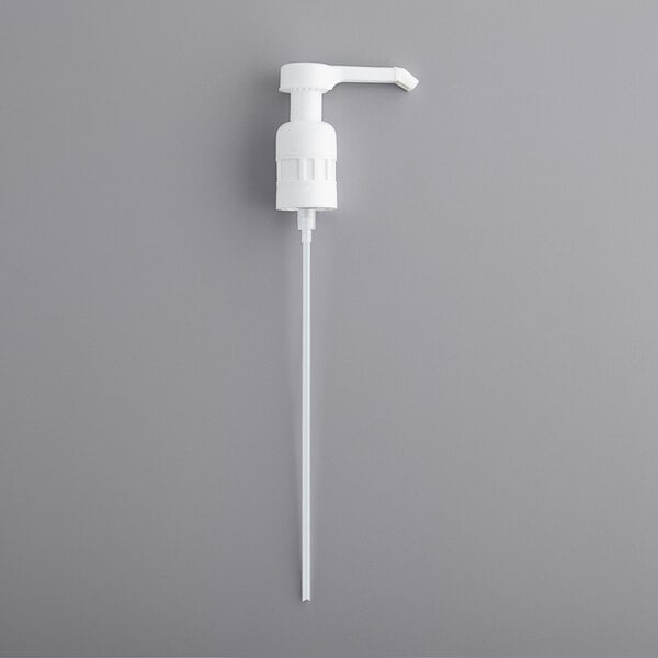 A white plastic pump with a long tube.