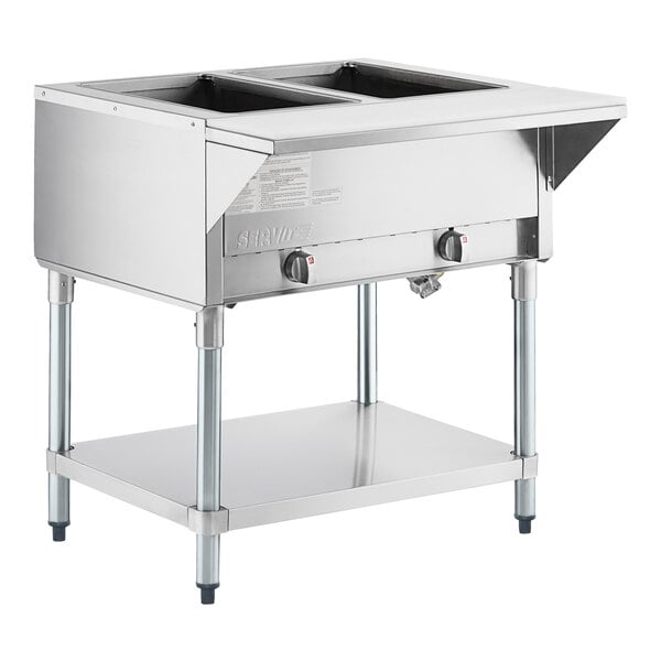 A stainless steel two-pan open well natural gas steam table with an undershelf and control knobs.