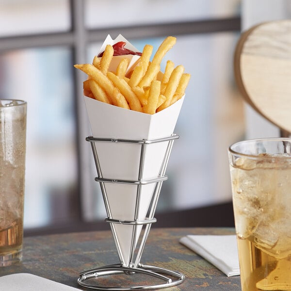 A Carnival King white cardboard fry cone filled with french fries on a table.