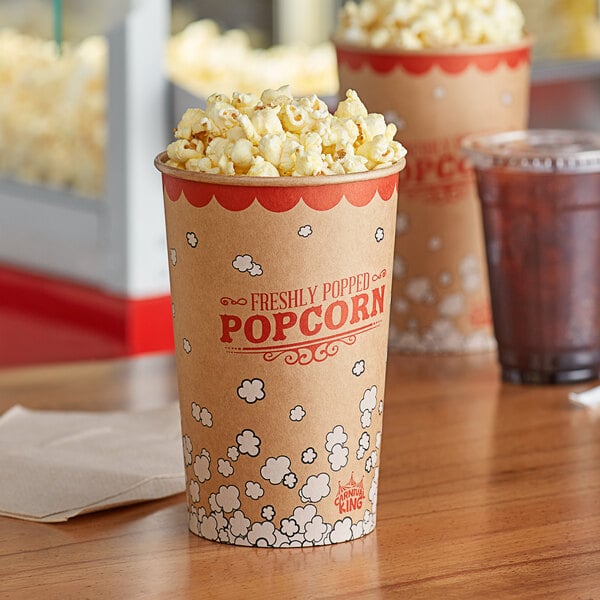 Two Carnival King Kraft popcorn cups filled with popcorn on a table.