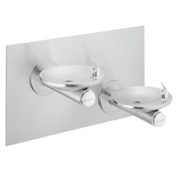 An Elkay stainless steel wall mount drinking fountain with two levels and splash-resistant oval basins.
