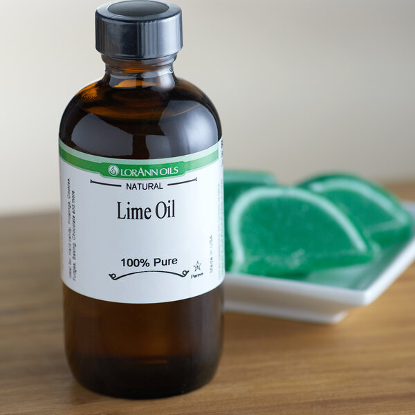 A bottle of LorAnn Oils Lime Super Strength Flavor on a wooden table.