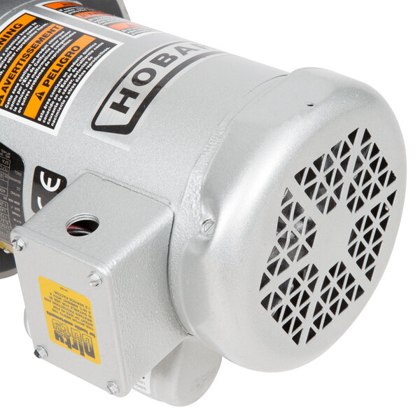 The short upper housing of a Hobart commercial garbage disposer with a silver motor.