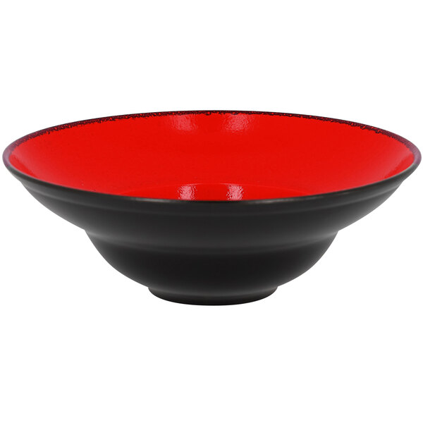 A red porcelain plate with a black rim.