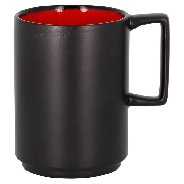 A black mug with red rim.