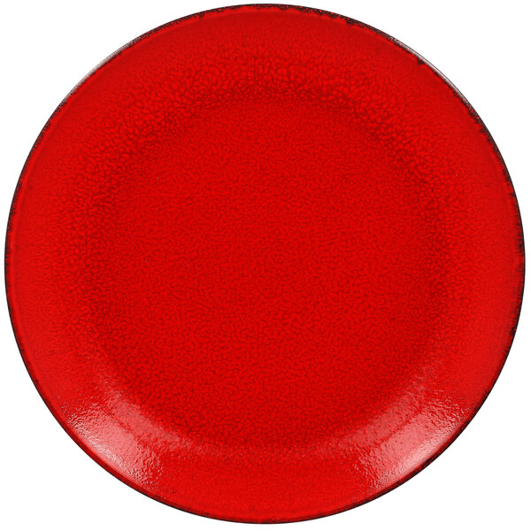 A red RAK Porcelain coupe plate with black speckled edges.