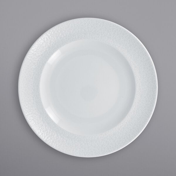 A RAK Porcelain white porcelain plate with an embossed white rim.