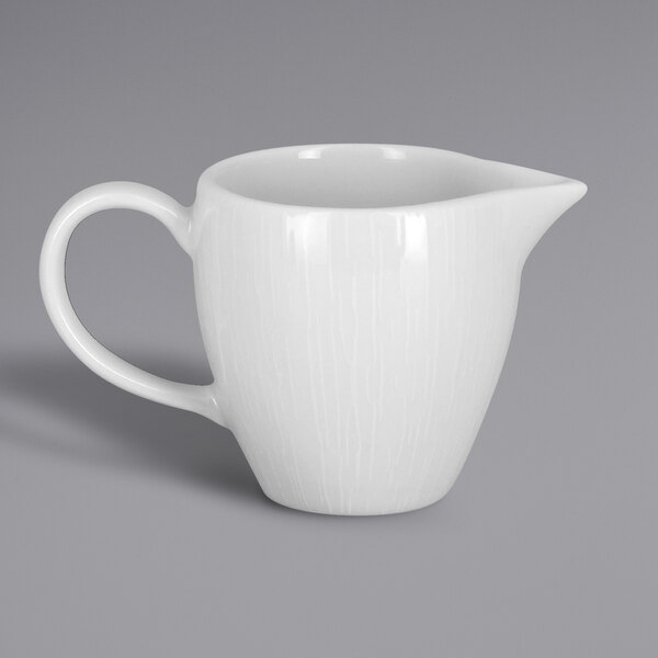 A white pitcher with a handle.