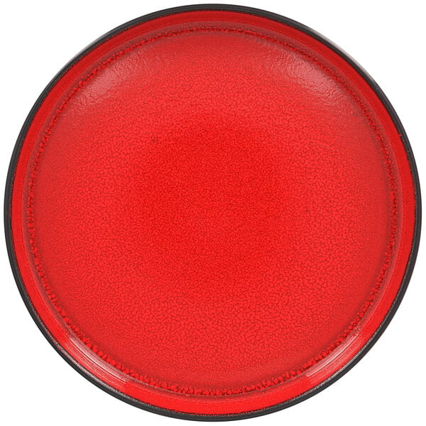 A white porcelain plate with a red center and black rim.