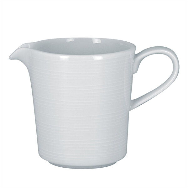 A white porcelain pitcher with a handle.