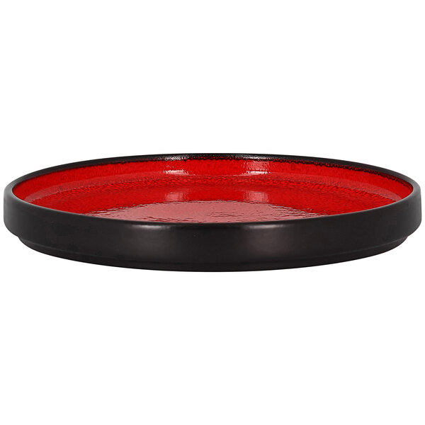 A red and black rimless porcelain plate.