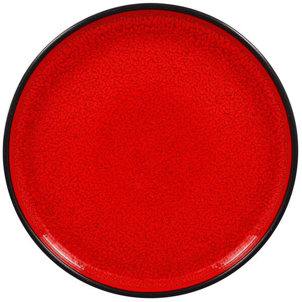 A red porcelain plate with a black rim.