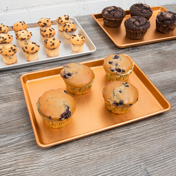 A Chicago Metallic bakery display tray with blueberry muffins in paper wrappers.
