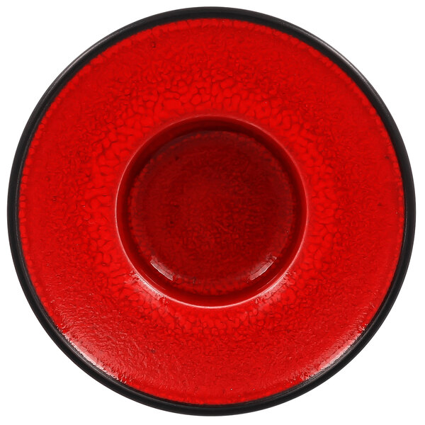 A red RAK Porcelain saucer with a black rim.