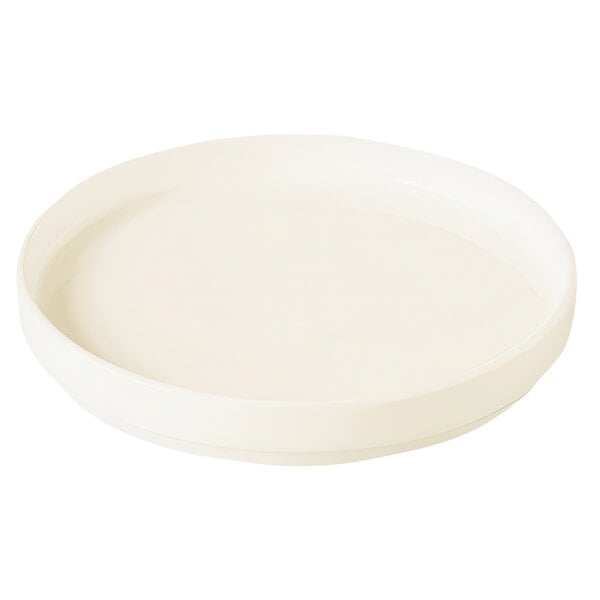 A RAK Porcelain warm white round rimless plate with a white background.