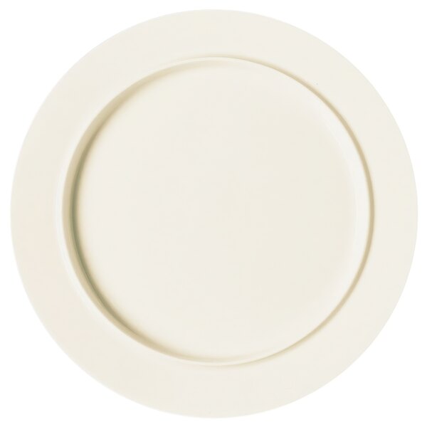 A close up of a RAK Porcelain white round flat rimmed plate.