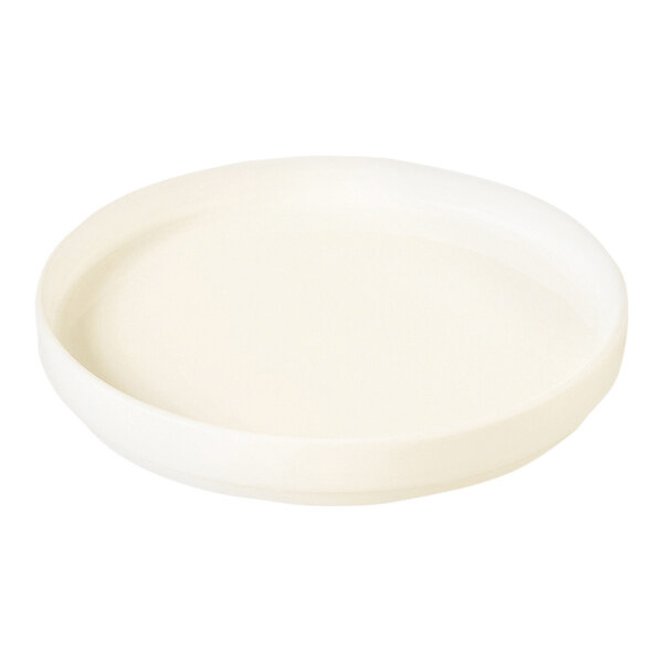 A white round rimless RAK Porcelain plate.