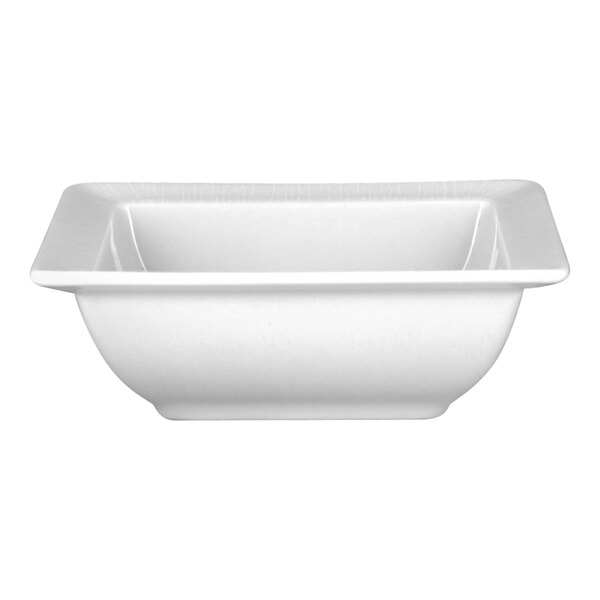 A bright white embossed square porcelain salad bowl.