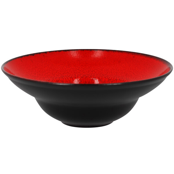 A red porcelain plate with a wide black rim.