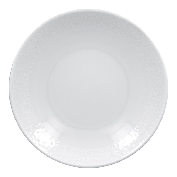A bright white, round, embossed deep coupe porcelain plate.