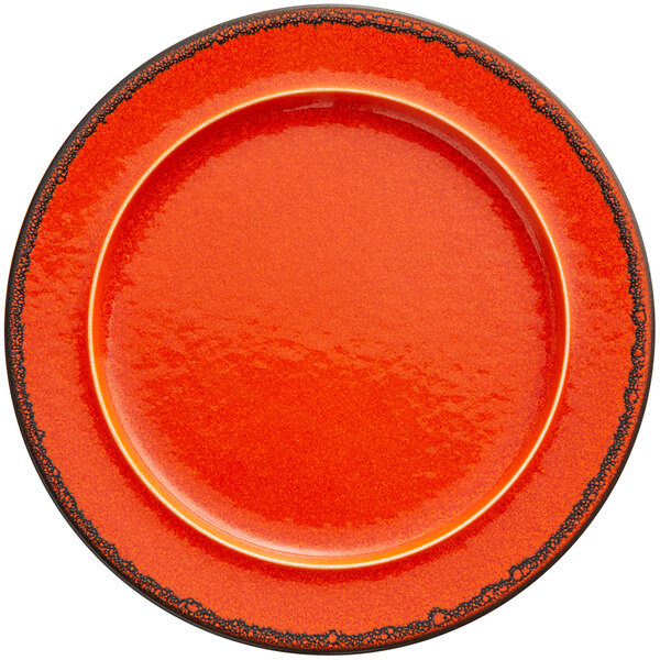 an orange plate with black rim