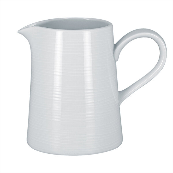 A RAK Porcelain bright white porcelain creamer with a handle.