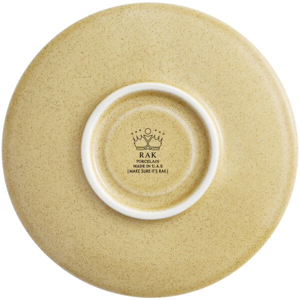 A RAK Porcelain Creme Brule saucer with a white rim and crown.