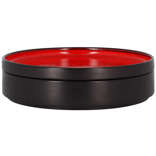 A red rimless porcelain deep plate with a lid.