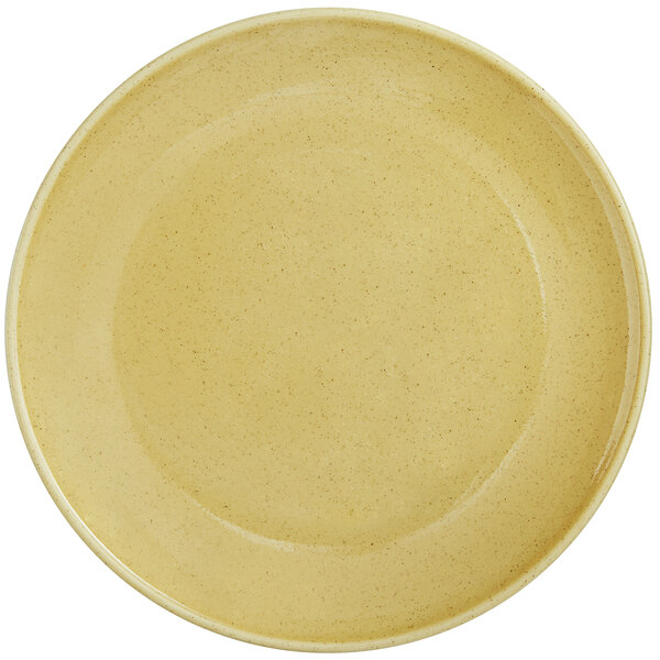 A close up of a yellow RAK Porcelain coupe plate with a glossy finish.