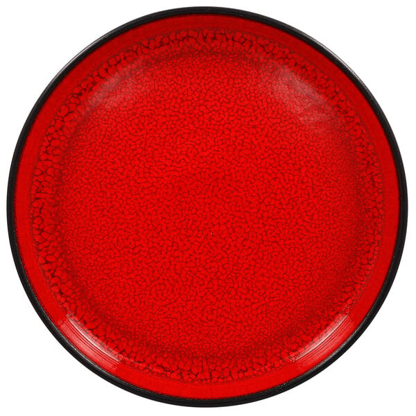 A white porcelain plate with a red center and black rim.