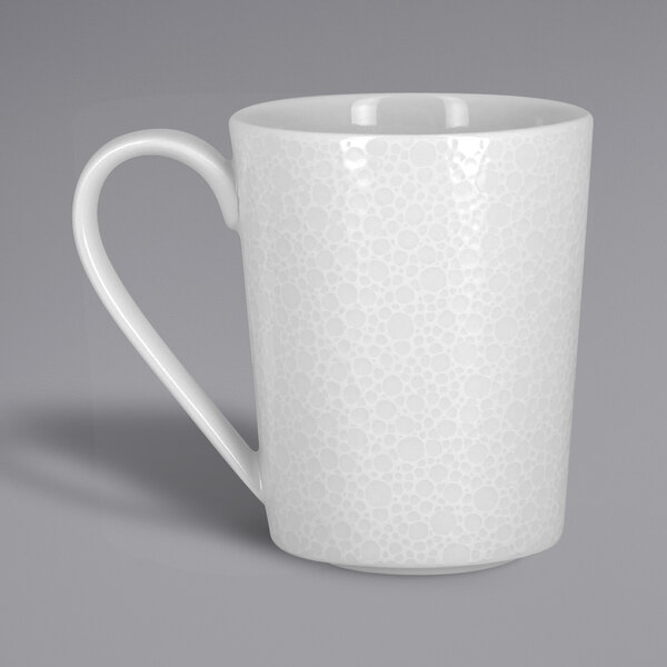 A close-up of a RAK Porcelain bright white mug with a handle.