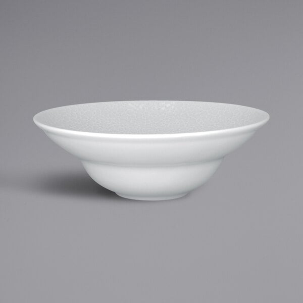 A RAK Porcelain extra deep white porcelain plate with an embossed design on the rim.